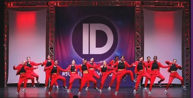 Dancers in red and black hip-hop costume on stage