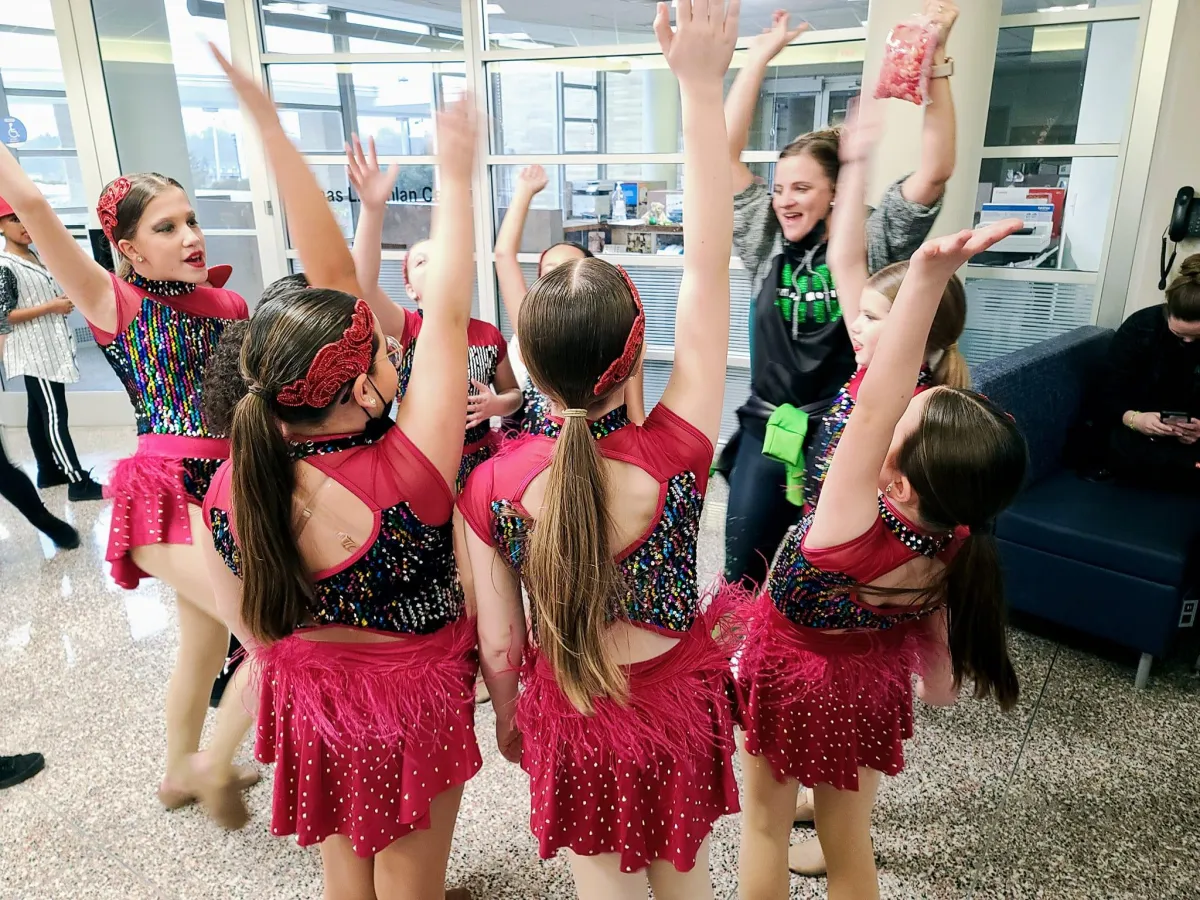 Dancers celebrating with group high five