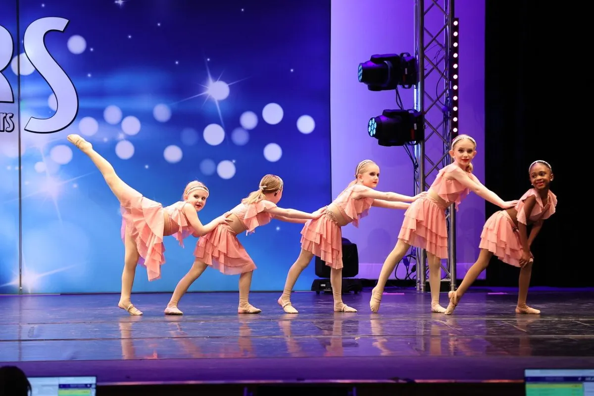 Dancers in lime green and black costume on stage