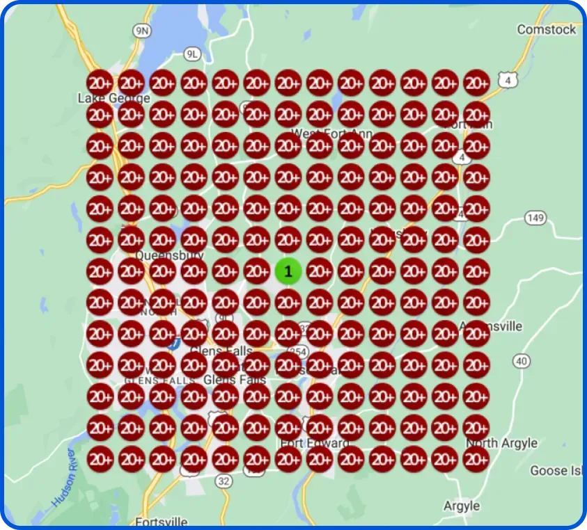 A heatmap of the Glens Falls, New York area. The entire grid is made up of dark red circles with the number "20+," except for a single green circle in the center with the number "1." This indicates extremely high numbers across the area with one exception.