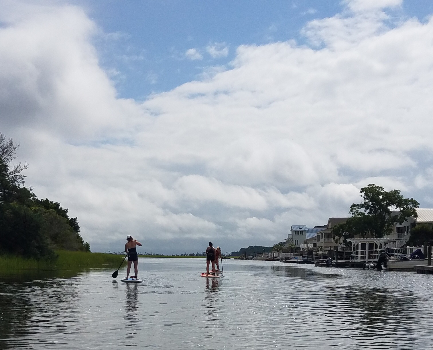 people paddleboarding out of the inlet