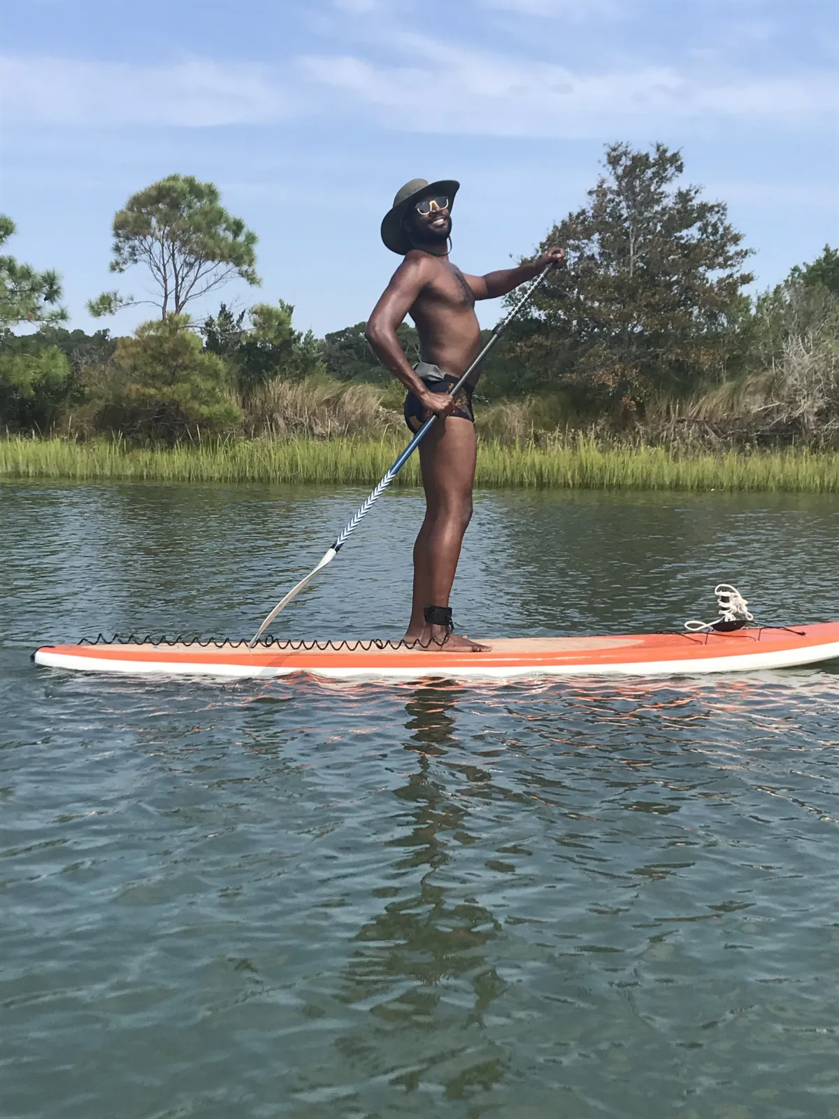 man standing on a paddleboard on the water
