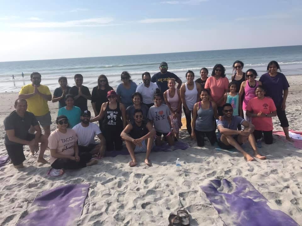 group of people on the beach in a group picture