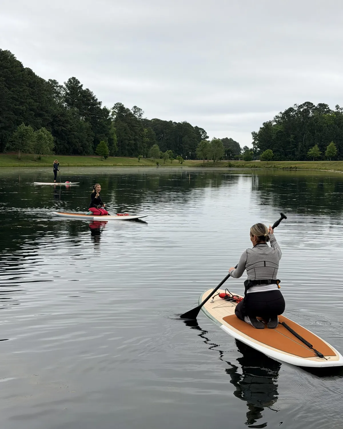 people paddling on paddle boards on the water