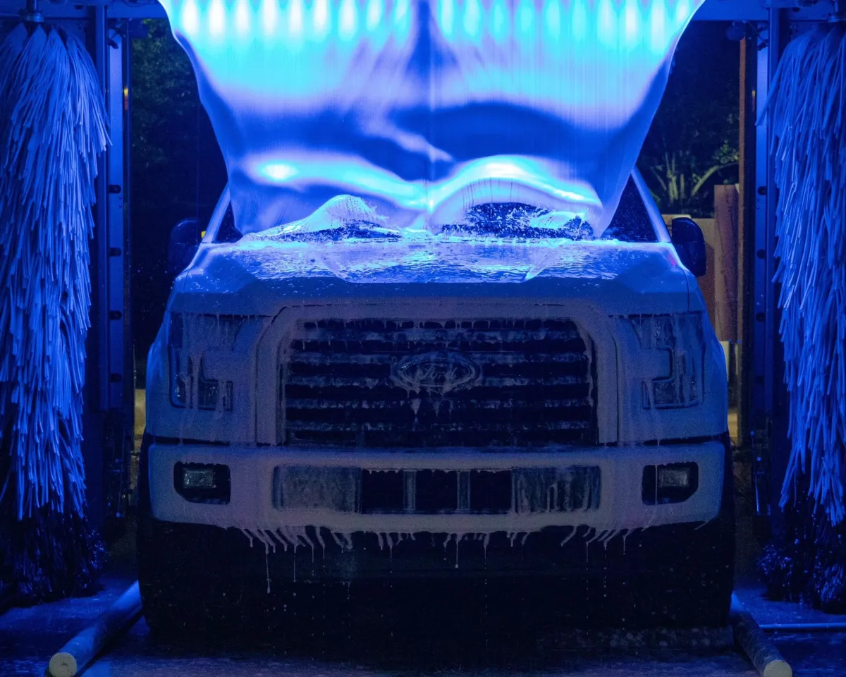 a car wash with cars parked in front of it