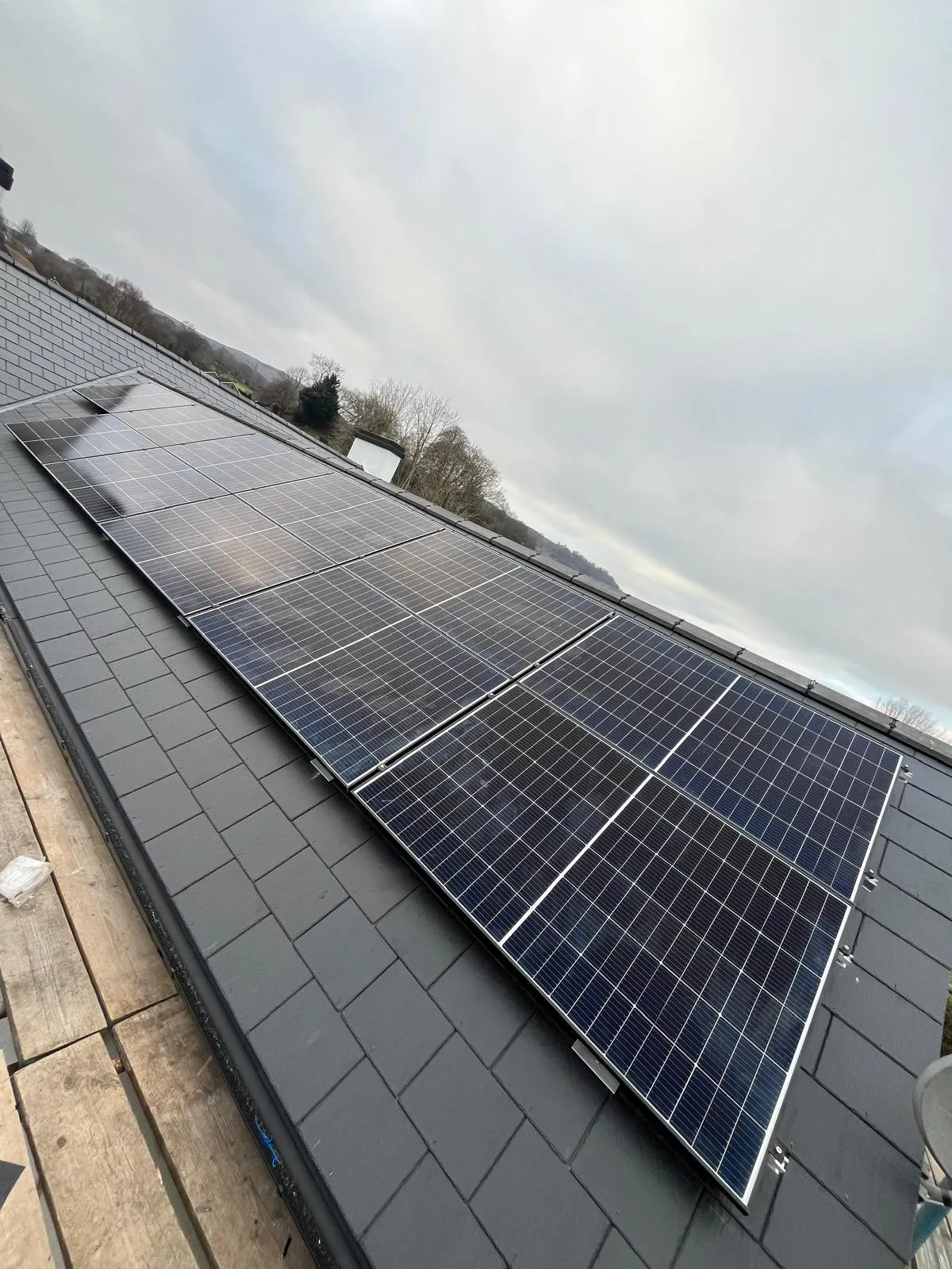 Newly installed solar panels on a slate roof