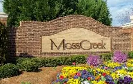 Entrance sign for Moss Creek neighborhood surrounded by flowers and landscaping in Concord, NC
