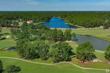 Composite deck with table, railing, and play area in Jack Britt neighborhood