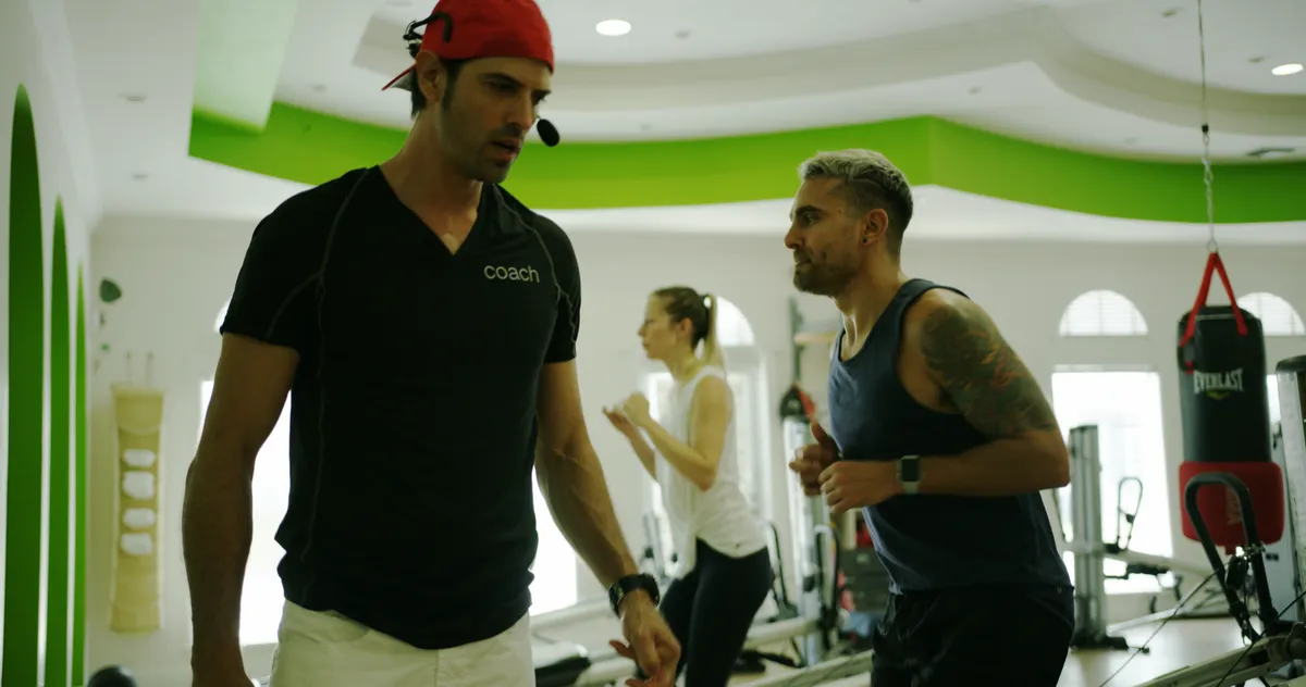 Coach Roberto guiding a client through a personalized strength and stability exercise at Morphē.