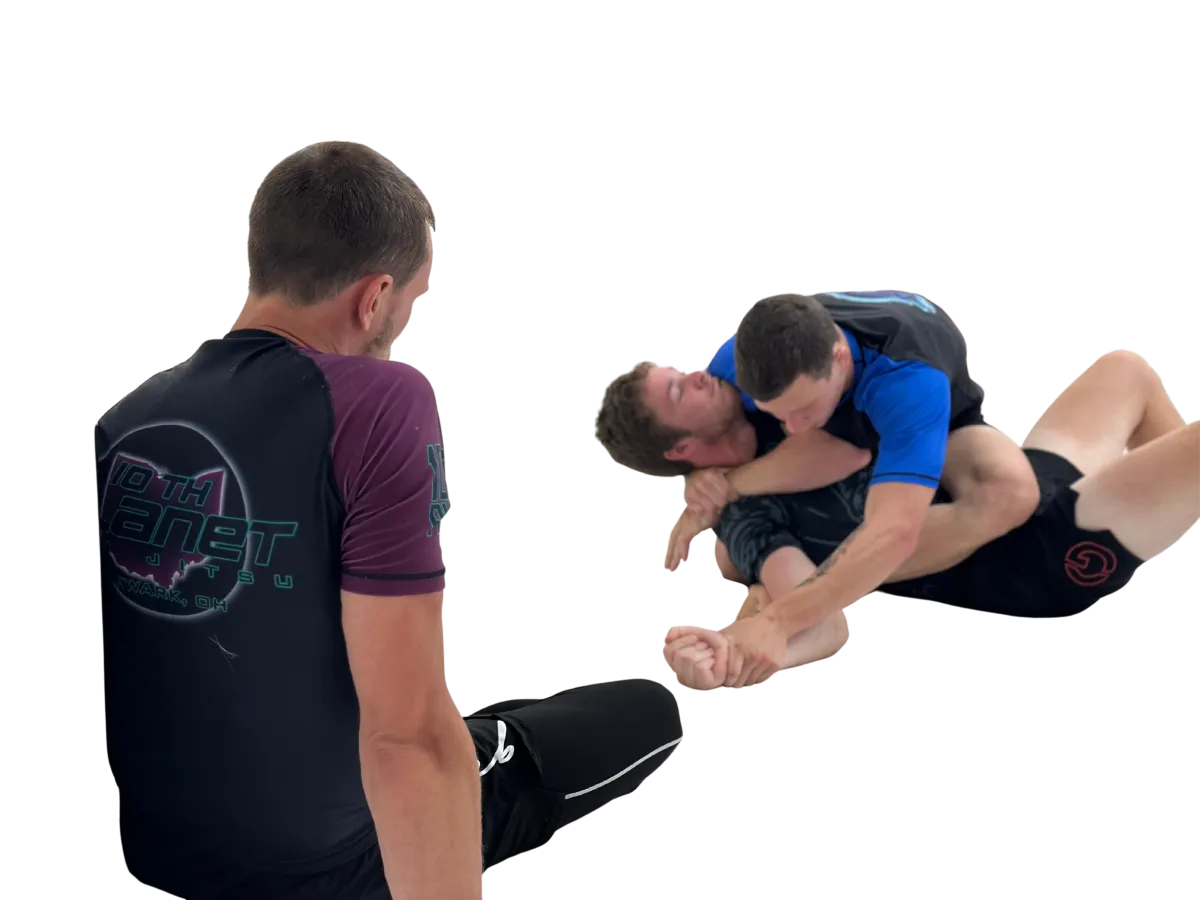 Diverse group of adults training Brazilian Jiu Jitsu on the mats