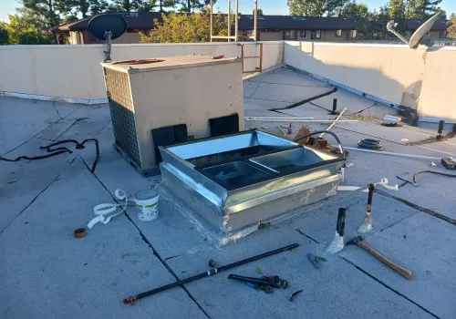 Technician cleaning air ducts and inspecting ventilation system