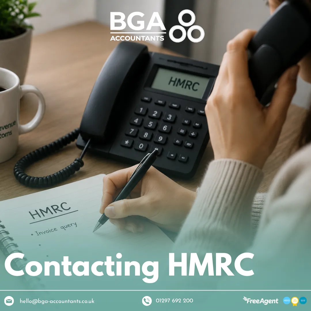 Person speaking on the phone beside an HMRC notepad and telephone, illustrating how to contact HMRC for tax queries and support.