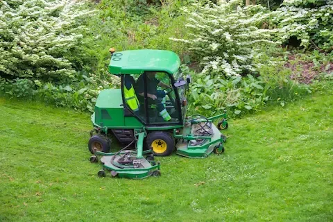 Riding commercial mower cutting large lawn | Brooklyn Park Lawn & Snow commercial mowing