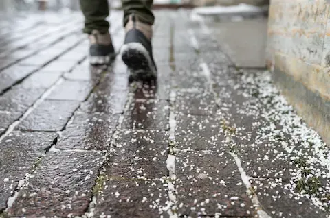 Salted brick sidewalk for icy conditions | Brooklyn Park Lawn & Snow winter walkway service