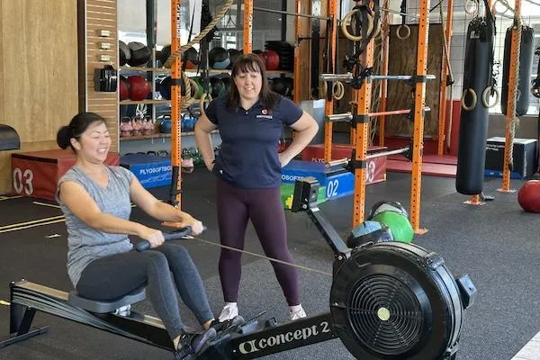 Coach Savitar with an athlete at the Empower gym
