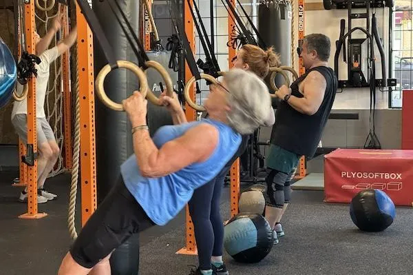 Athletes 40+ performing ring rows in Vancouver