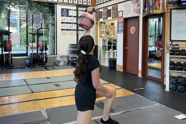 Athlete doing a Turkish getup with a kettlebell in Vancouver