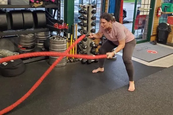 40+ female athlete working the ropes at Empower