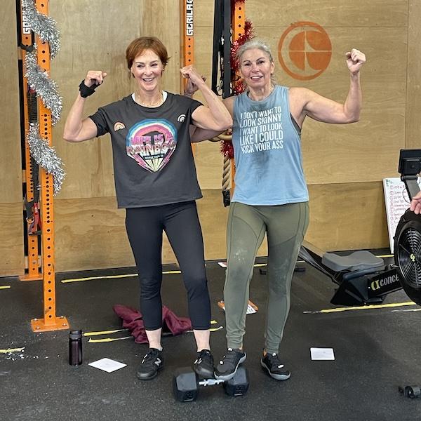 Two female 40+ athletes celebrating at Empower