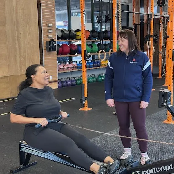 Coach Jo with senior athlete on rower