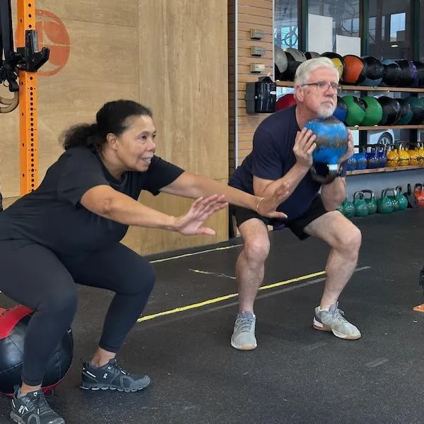 Two Strong Over 60 athletes doing squats