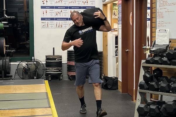 HYROX training sandbag carry