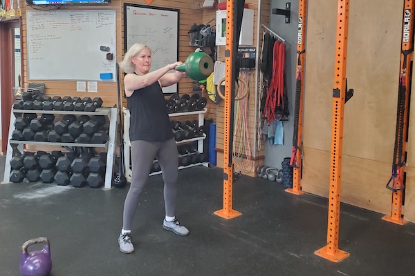 Two athletes completed one armed kettlebell snatches