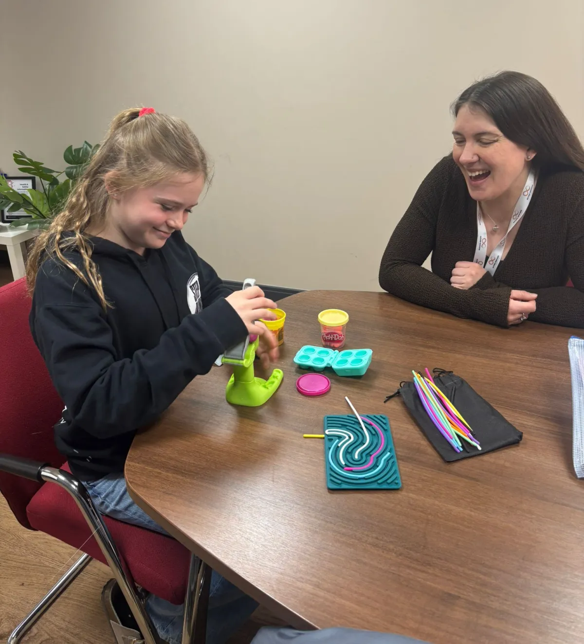 Child engaged in an interactive sensory and developmental assessment with a clinician