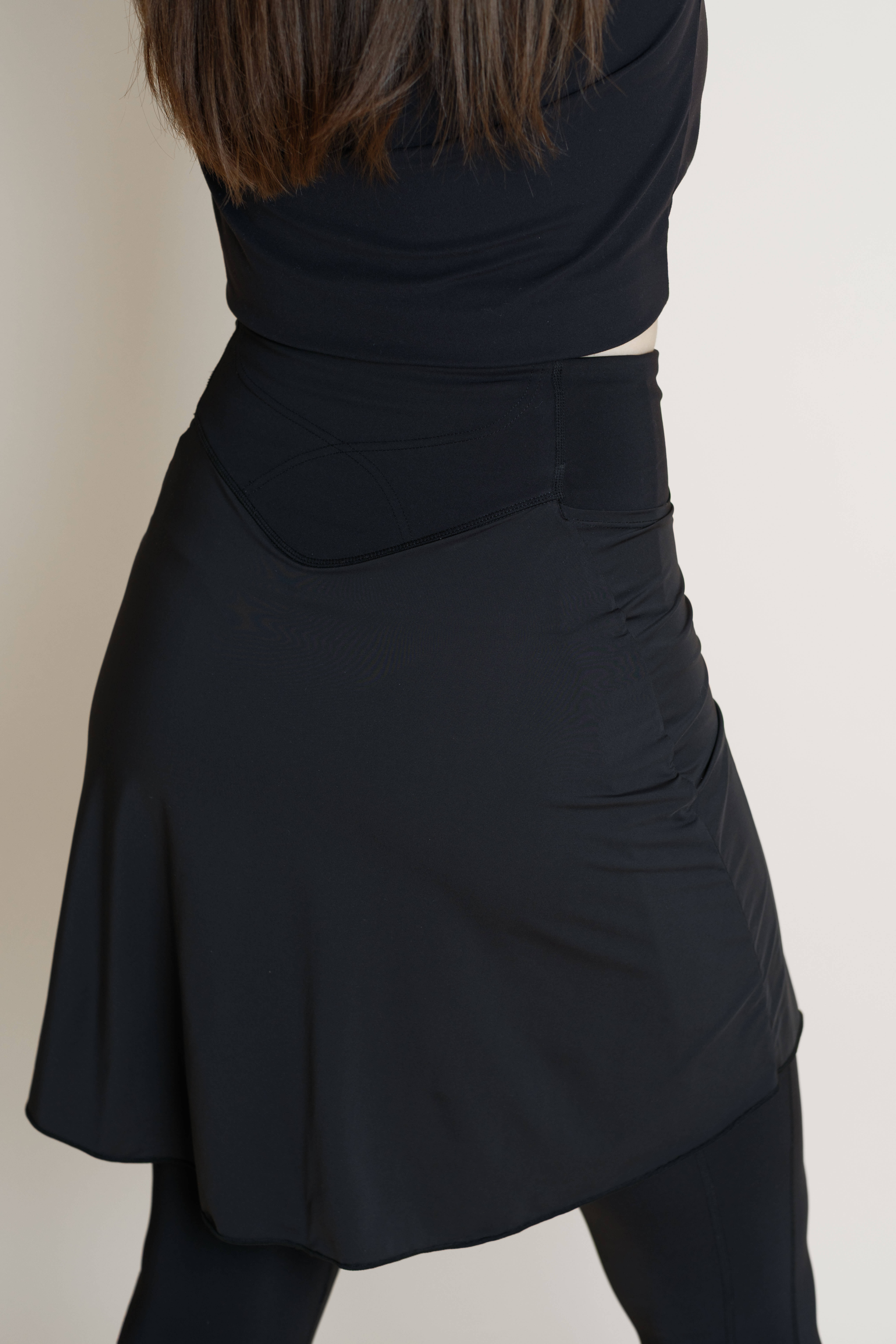 Back view of black modest athetic skirt with built in leggings