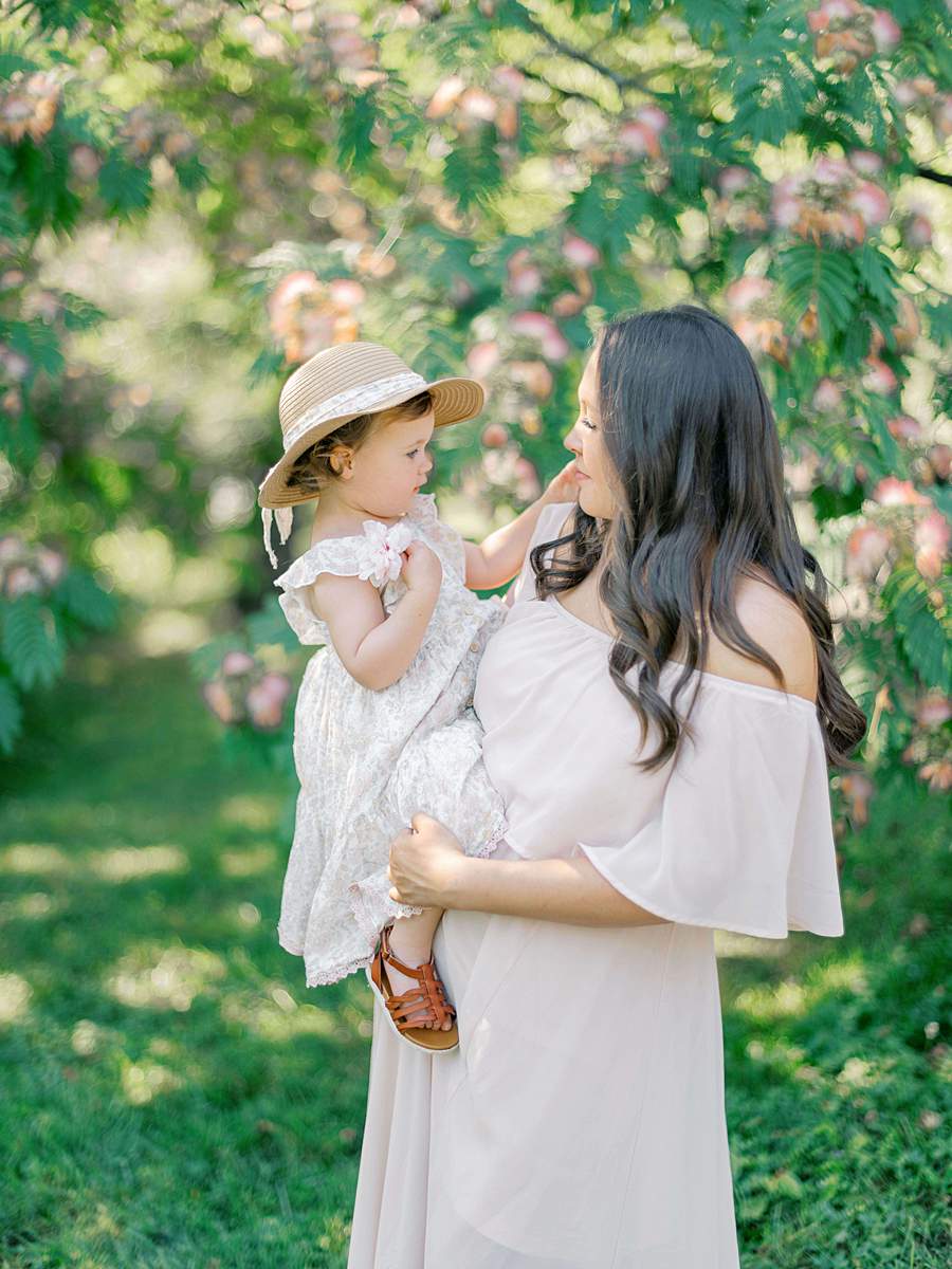 Mother holding toddler in a sunlit flower field, Tri-Cities TN
