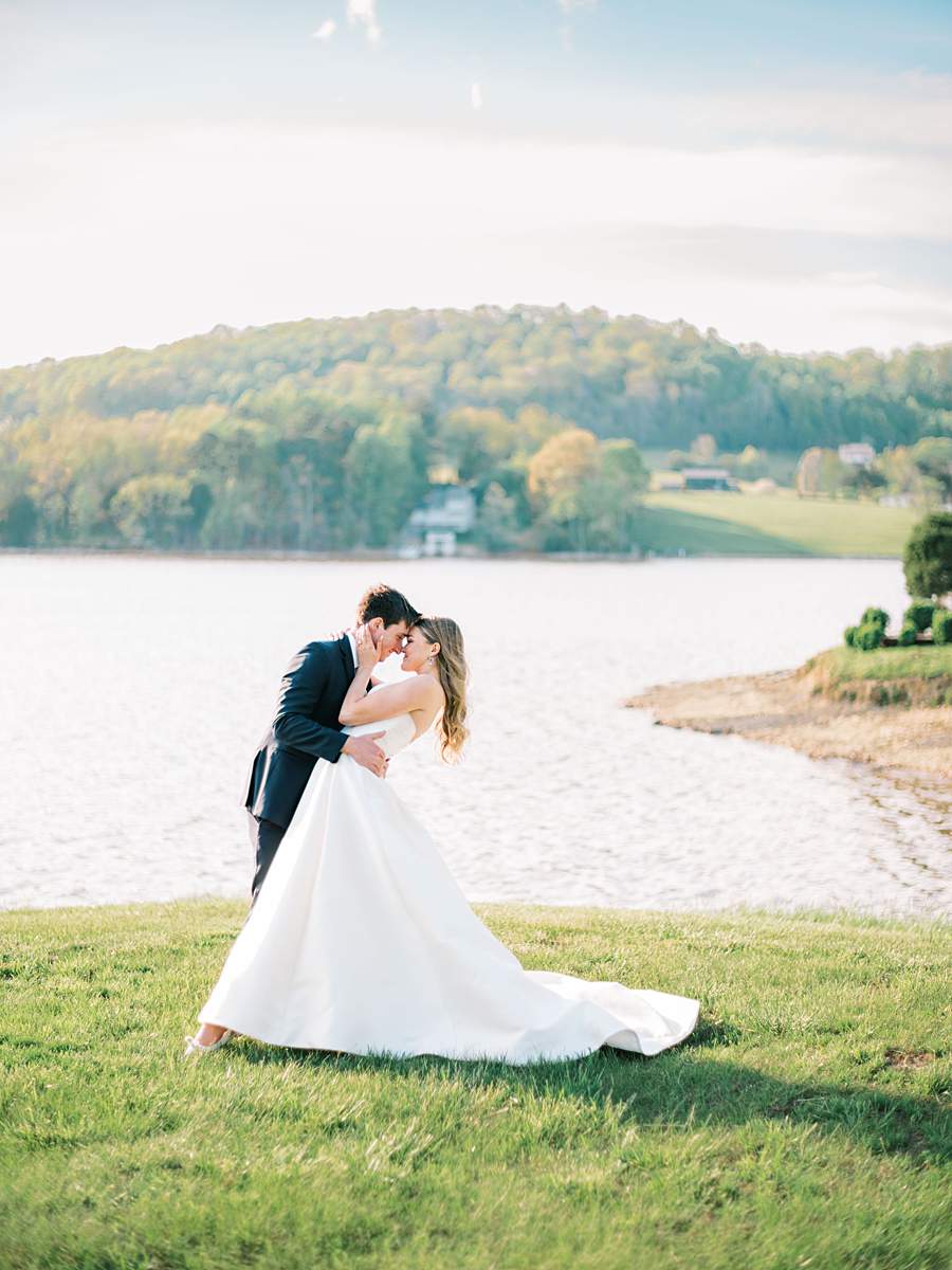 Bride and groom sharing an intimate moment with boone lake in the background, east tn.