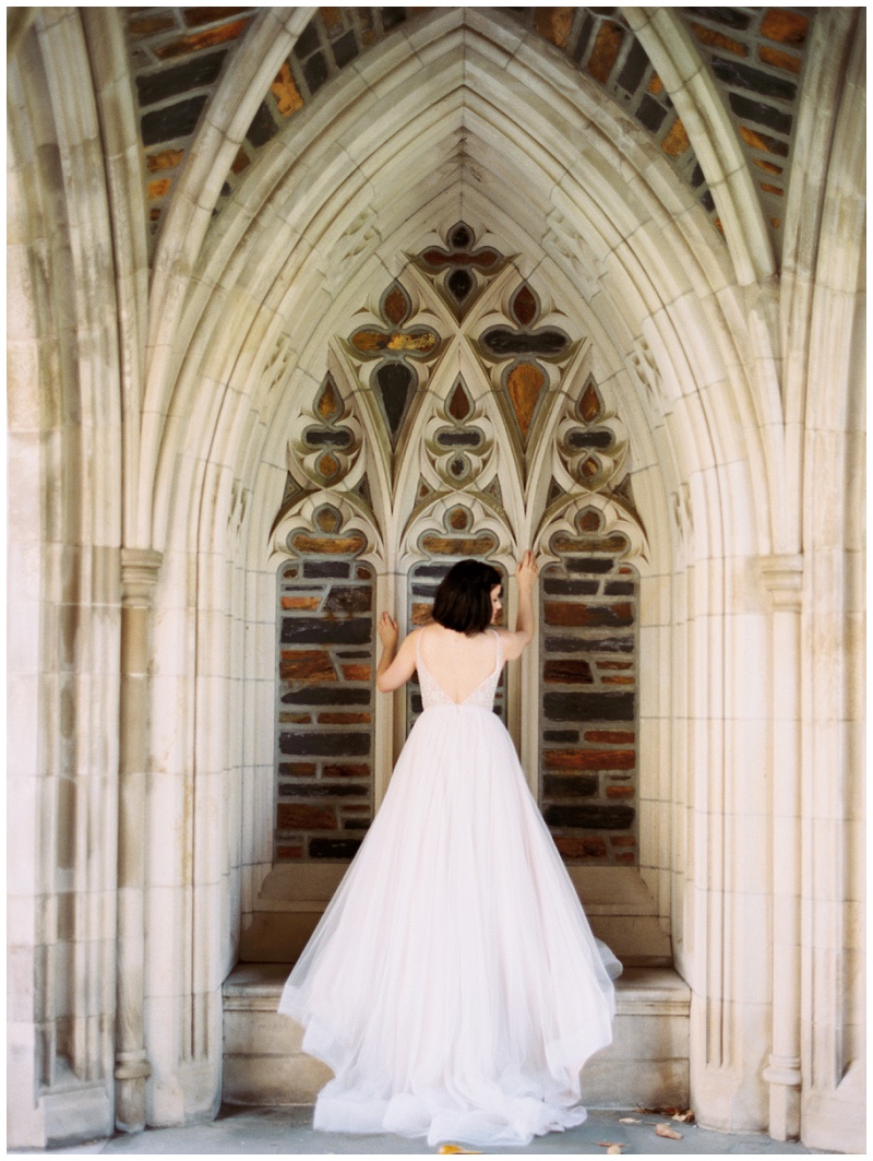 Bride walking through Duke campus near the chapel for Duke University Chapel wedding photos