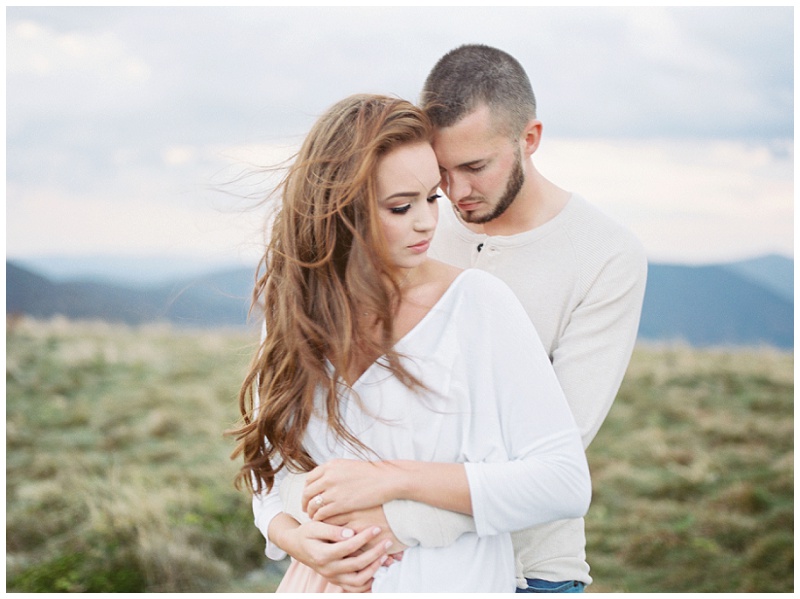 Holding hands and exploring trails at Roan Mountain TN engagement session