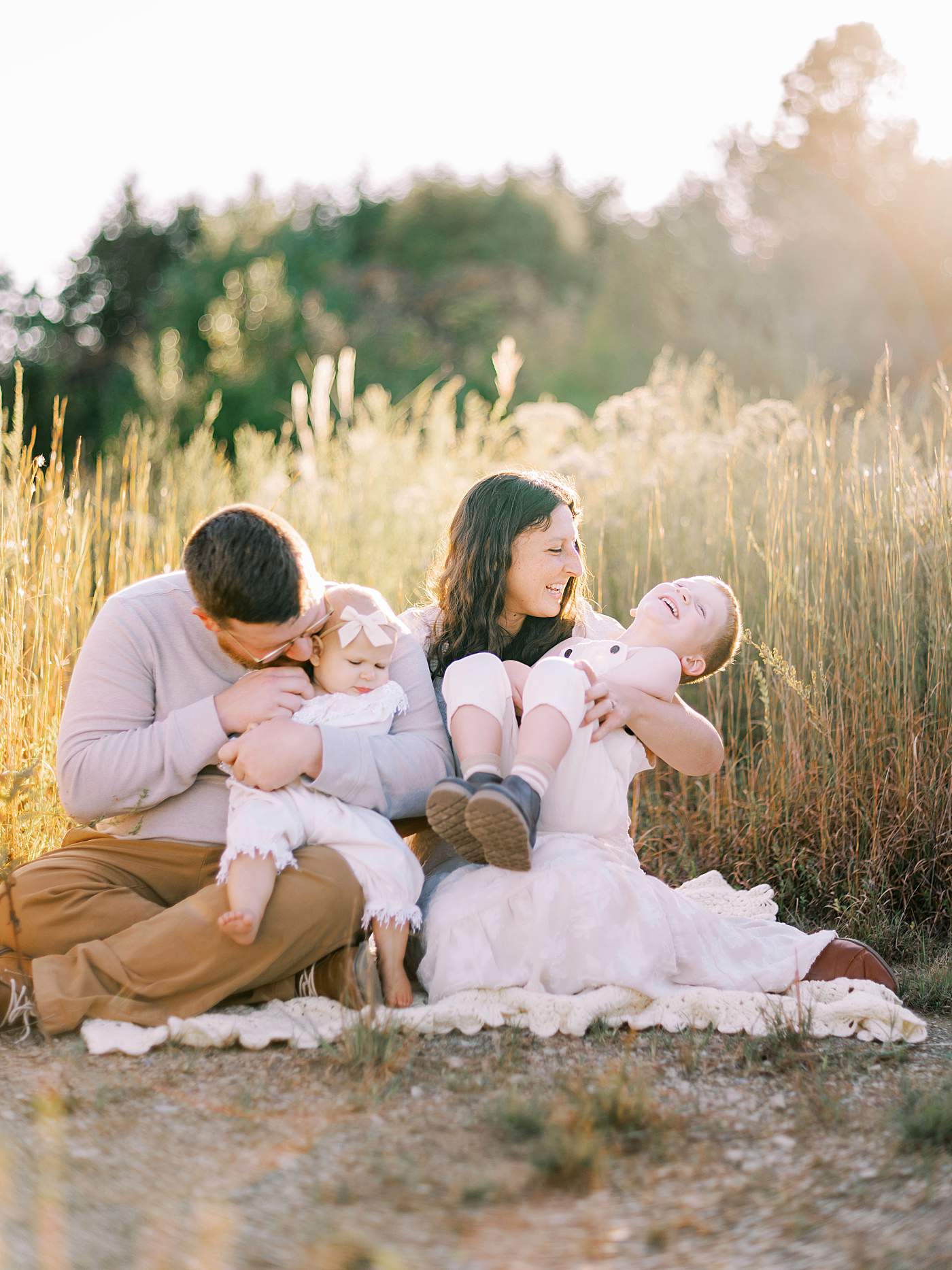 Family cuddling together during sunset photography session in Tennessee
