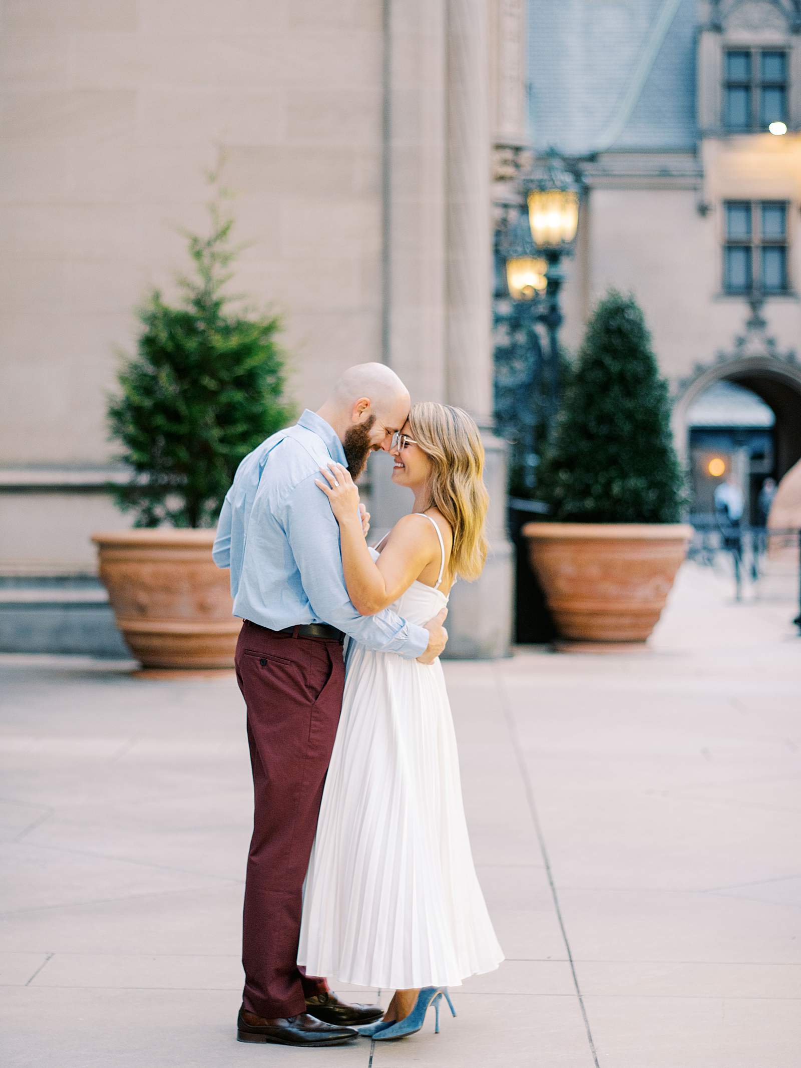 Engagement couple holding each other during a golden hour outdoor photography session in natural light