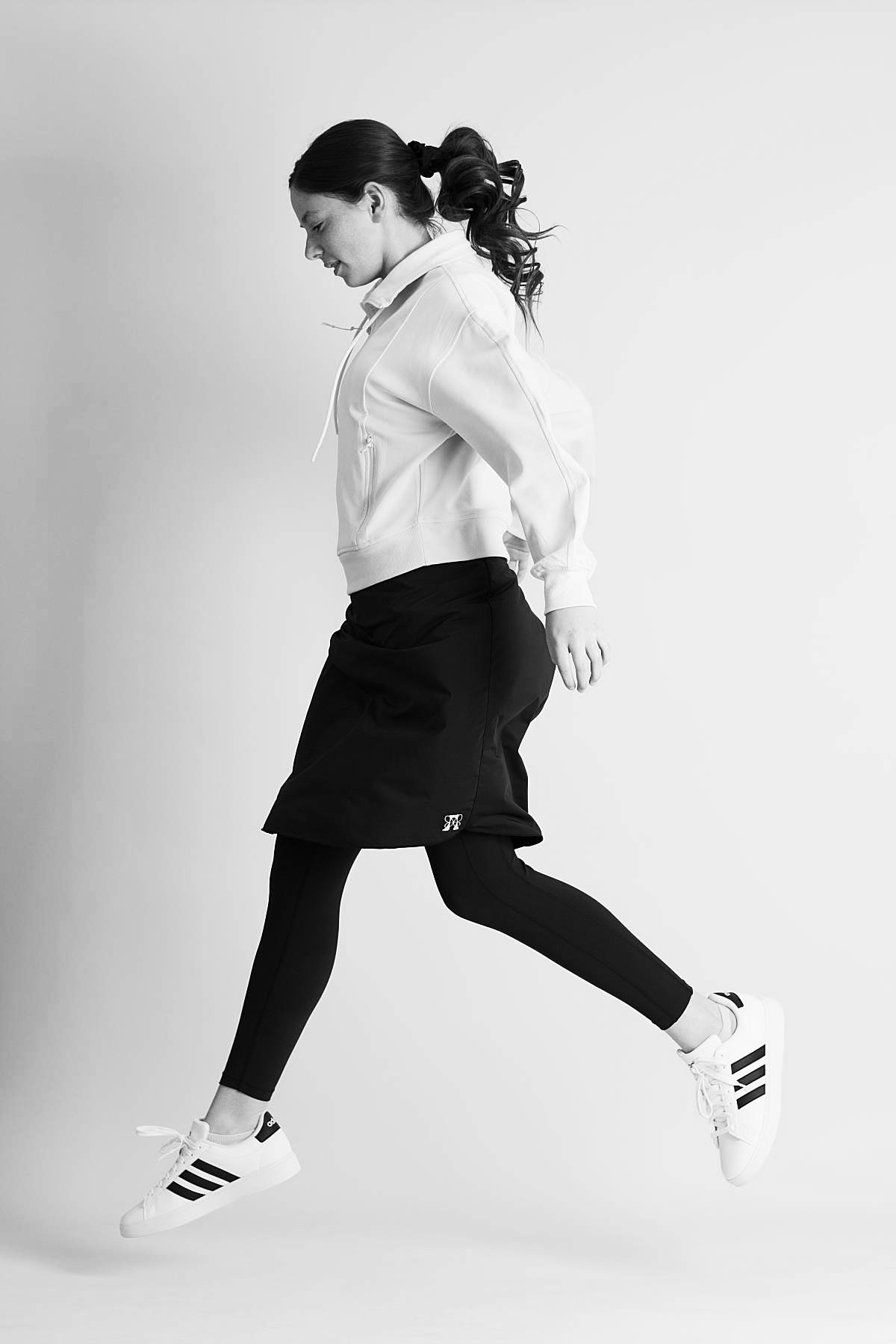 Back view of a grey modest athletic skirt that has a large back pocket