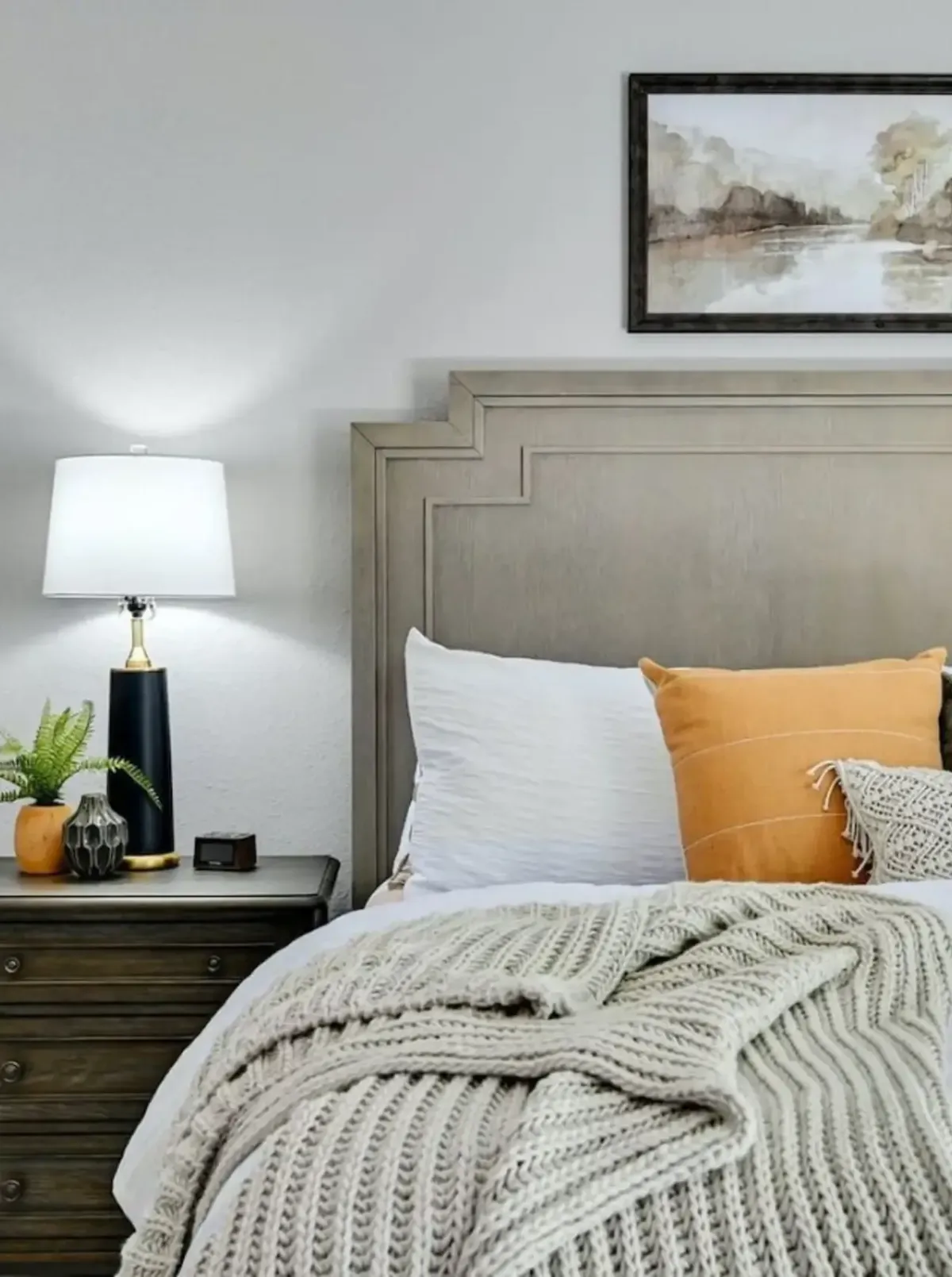 woman setting sheets on bed