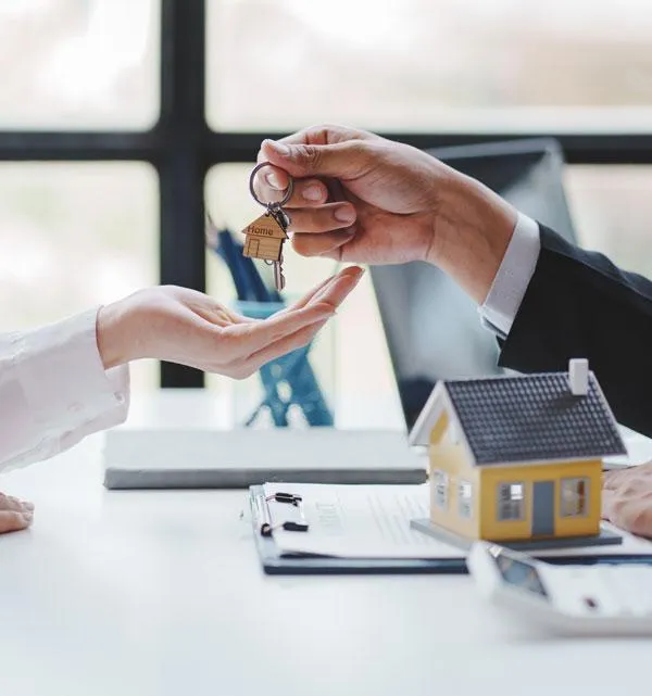 mans hand giving keys to womans hand