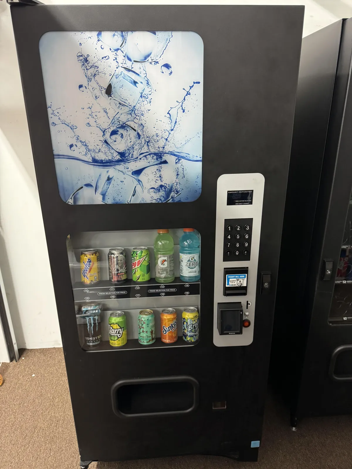 Two yellow vending machines with drinks inside.