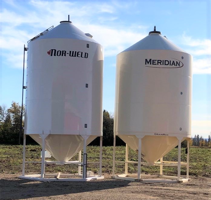 Donated NorthForge grain bin installation with volunteers at midday