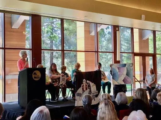 Christine Smith speaking in front of a crowd