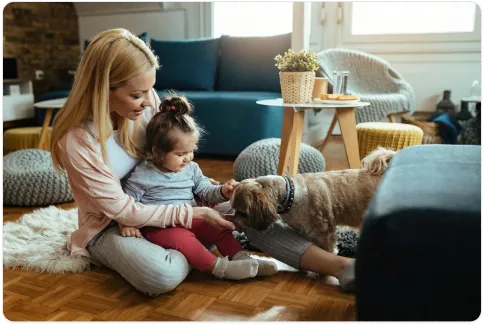 Woman, child, and dog on a sofa