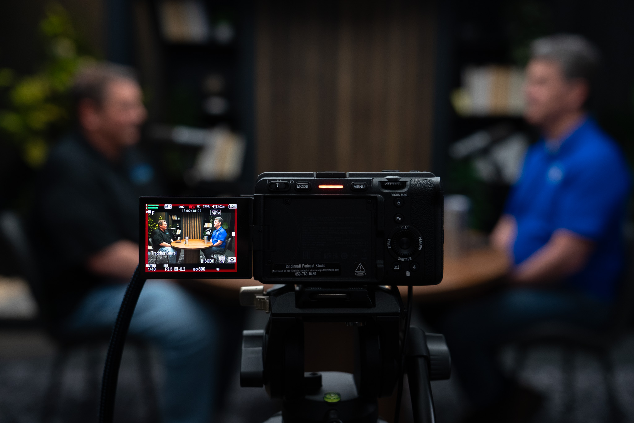 Camera monitor framing a podcast guest during a professional studio recording session