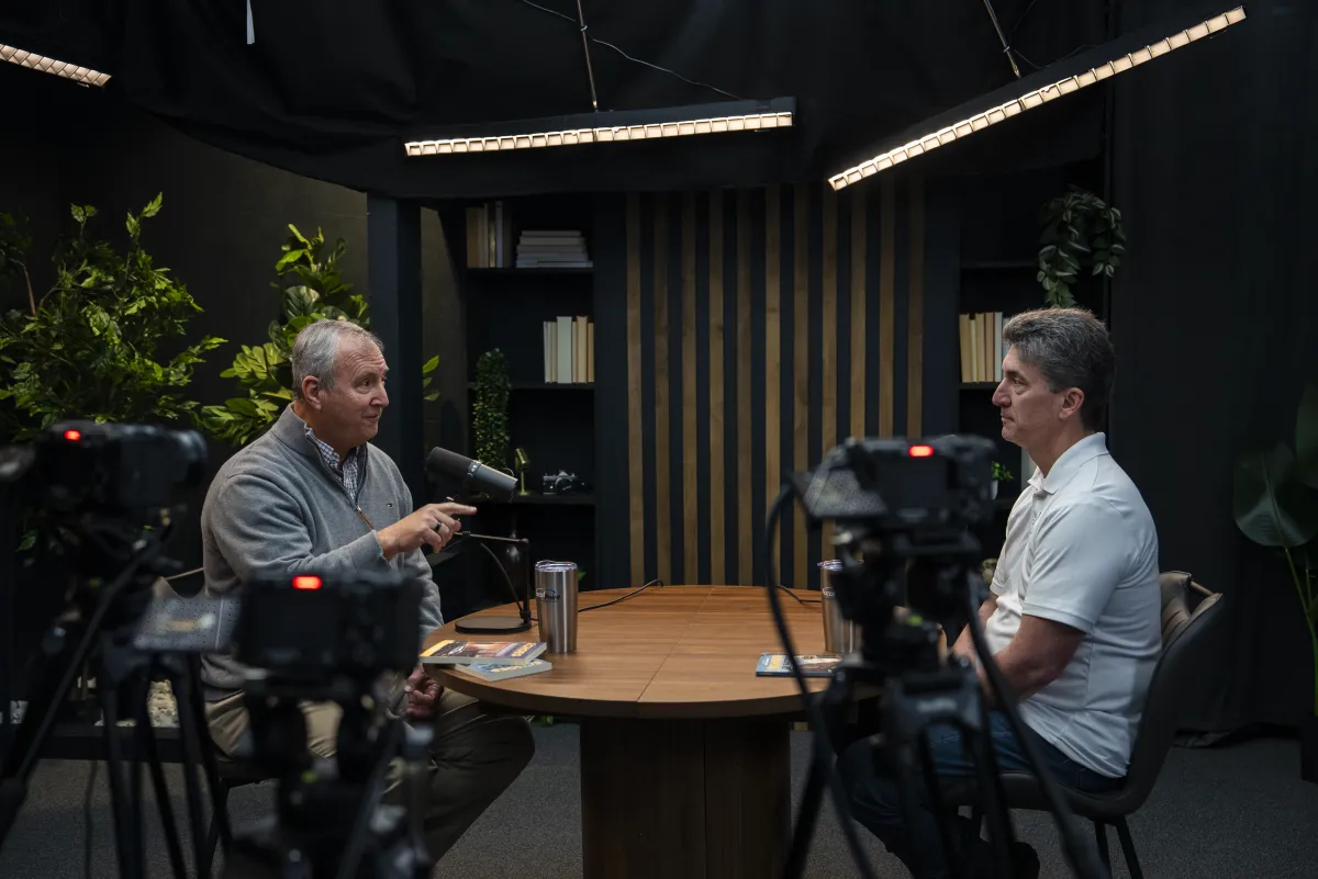 Behind-the-scenes view of a business podcast interview in production at a professional studio