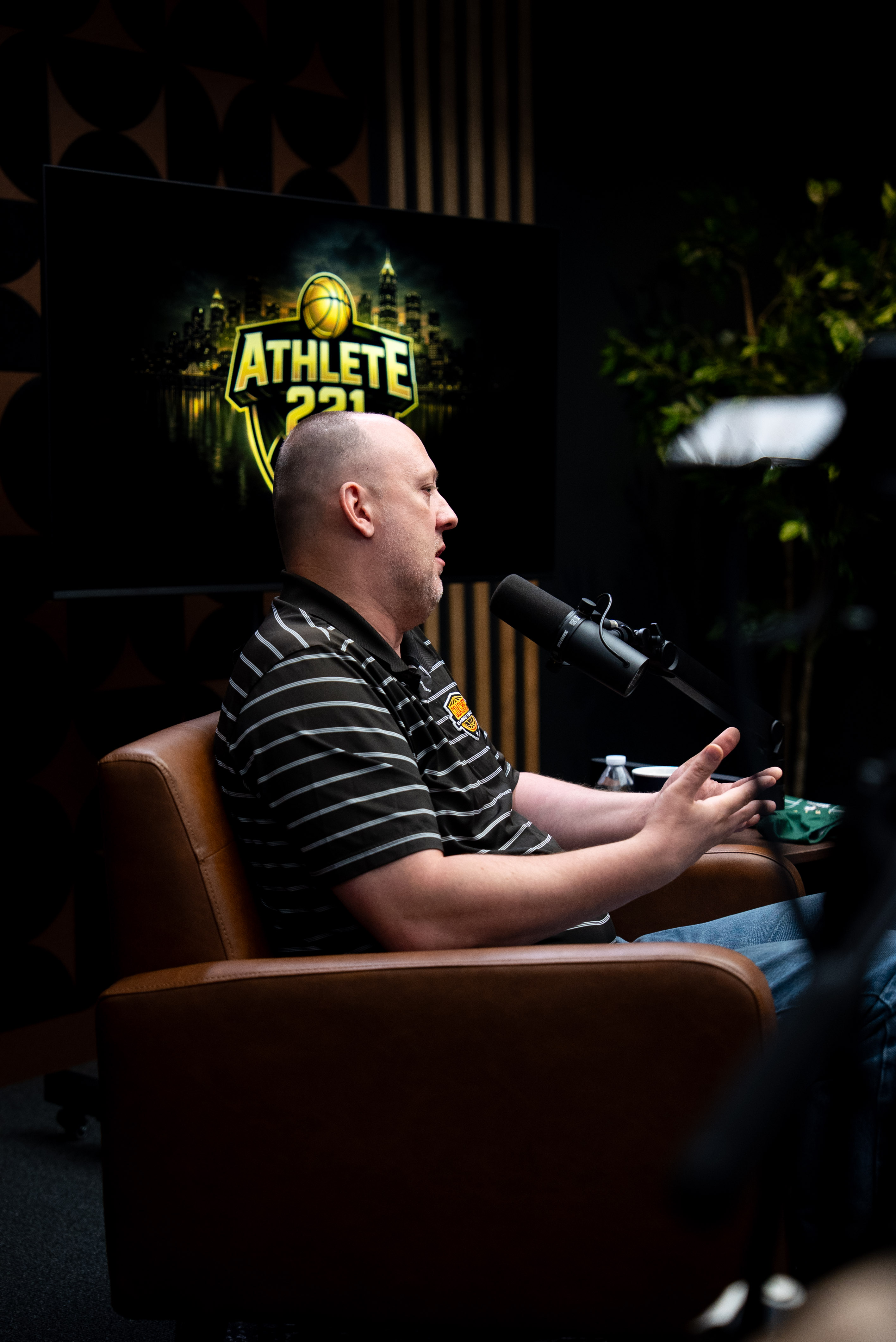 Business professional speaking on camera in a podcast studio during a short-form video recording session