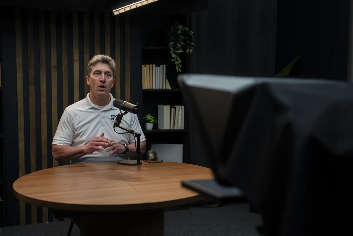 Host recording a solo segment at a podcast desk for short-form video clips
