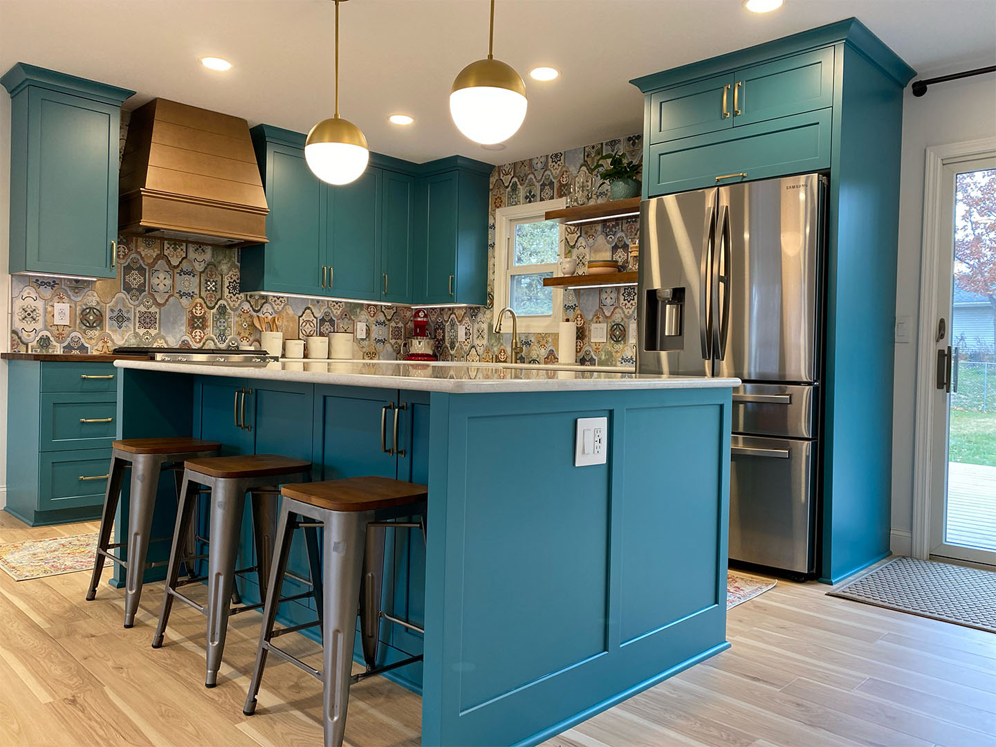 Project manager reviewing 3D design plans with a homeowner in their Twin Cities kitchen