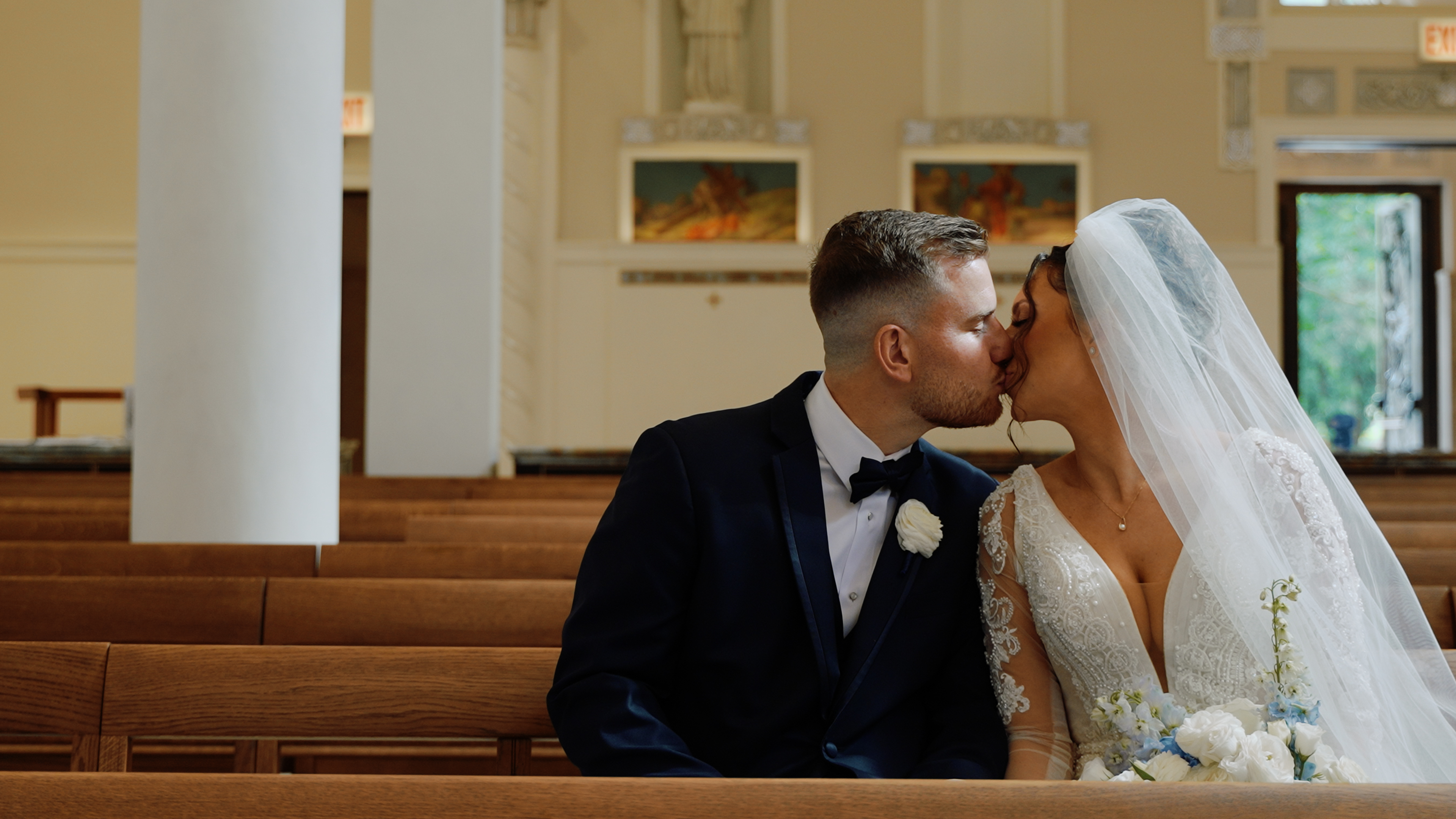 Wedding videographer filming couple at Our Lady of Pompeii, Chicago skyline
