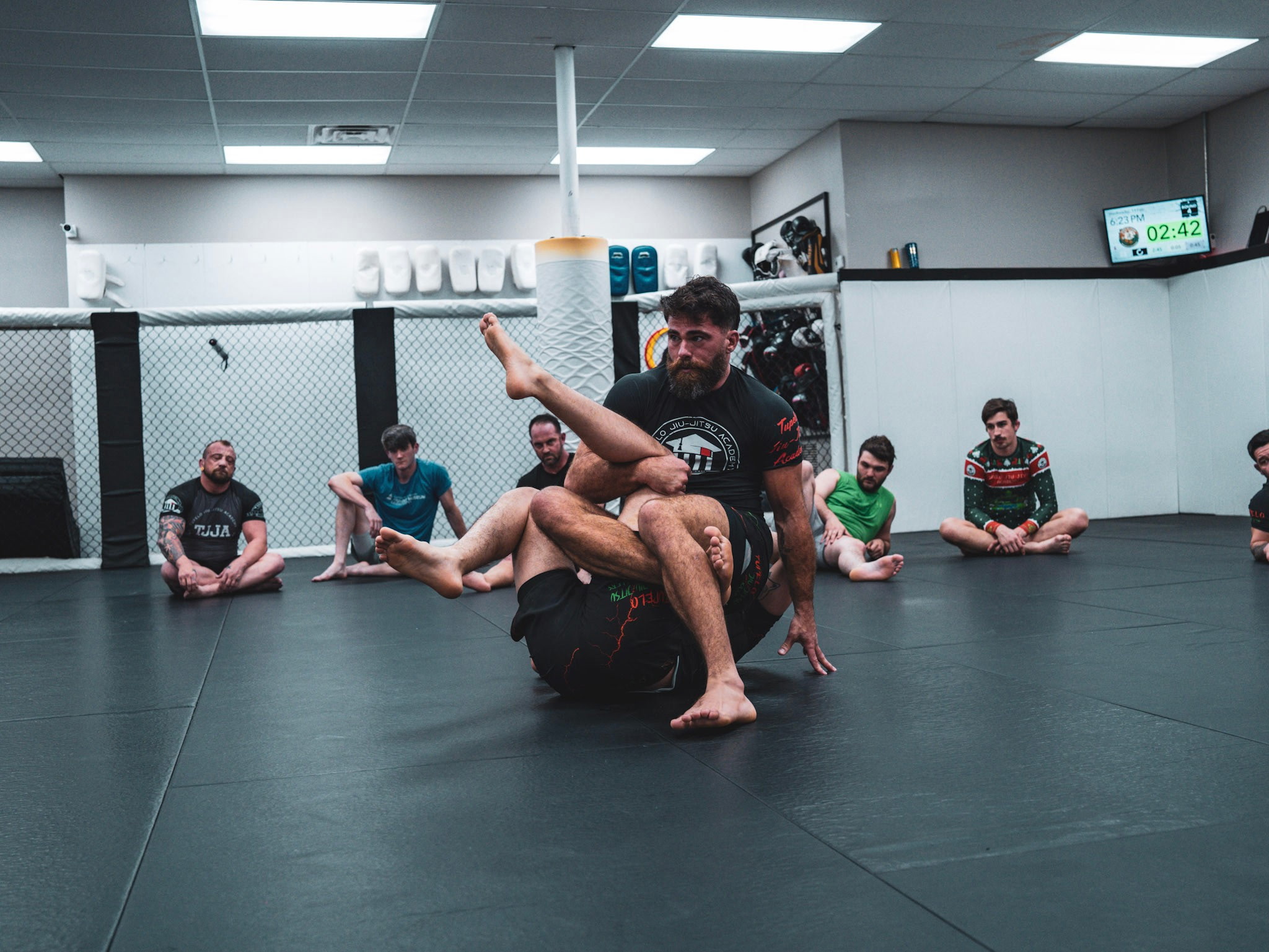 1. Brazilian Jiu Jitsu instructor demonstrating a grappling technique during class at Tupelo Jiu Jitsu Academy