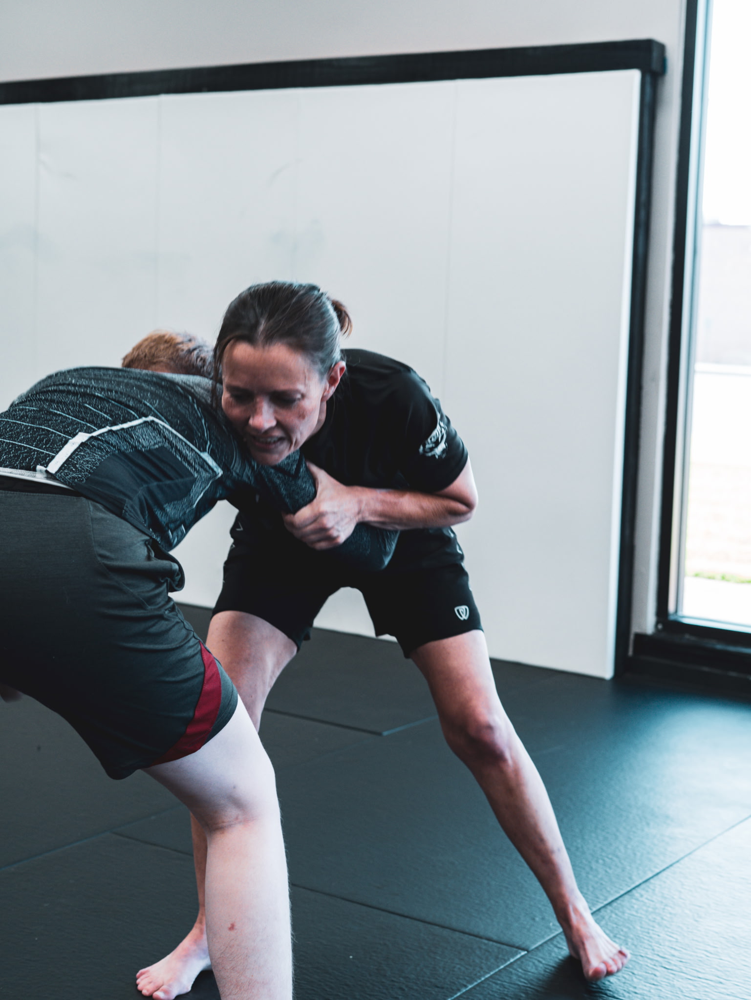 Women practicing No-Gi Brazilian Jiu Jitsu during class at Tupelo Jiu Jitsu Academy
